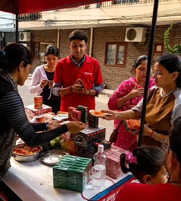 Badshah Masala product sampling and cooking demonstration in a residential community